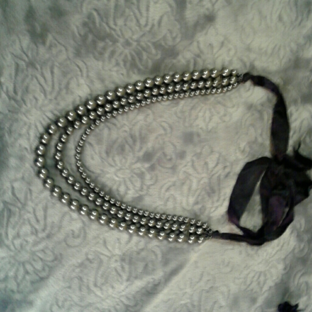 Three strand black pearls with black ribbon tie